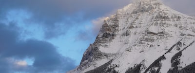 A photo of a mountain with snow on the top