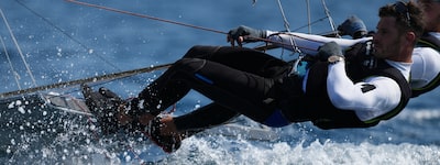 Example image showing two men leaning out on a yacht at speed, with focus on the eye of the man in front