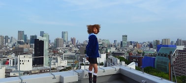 Image of a model with a cityscape in the background, shot on the ZV-1 II