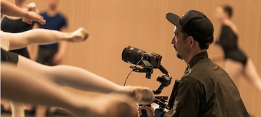 Usage image showing a photographer shooting a ballet rehearsal with a camera mounted on a gimbal