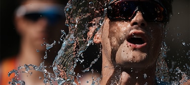 Example image of a triathlete splashing water onto his face