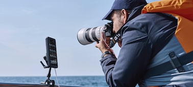 Usage image of a man shooting with a camera connected to PDT-FP1