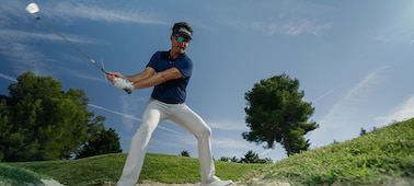 Example image of a golfer singing for a bunker shot, moments before hitting the ball